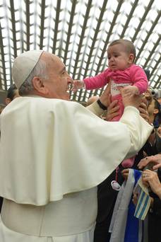 Pope Francis, pictured with a child at the Vatican, has sparked a row after he appeared to back a parents’ right to smack a naughty child.