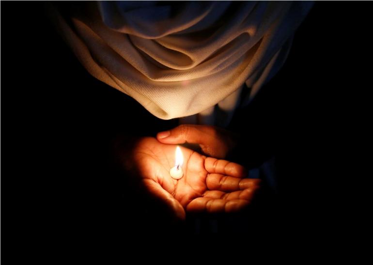 IN PHOTO: A Christian holds a candle during a vigil to show solidarity with the nun who was raped during an armed assault on a convent school, in New Delhi March 16, 2015. Christians in India said on Monday that the Hindu nationalist government of Prime Minister Narendra Modi had not done enough to protect their religion, after a spate of attacks including the rape of the 75-year-old nun at the weekend. Christians prayed and held vigils across the country to protest against the rape during an armed assault on a convent school, the worst in a series of incidents that followers of the faith say are making them feel unwelcome in their own country. REUTERS/Anindito Mukherjee