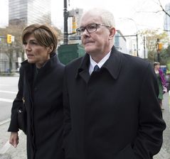 John Furlong and Renee Smith-Valade leave British Columbia's Supreme Court in Vancouver, Monday, March 30, 2015. A lawyer for Furlong has asked a B.C. Supreme Court judge to dismiss a sexual abuse lawsuit against his client and award special costs. THE CANADIAN PRESS/Jonathan Hayward