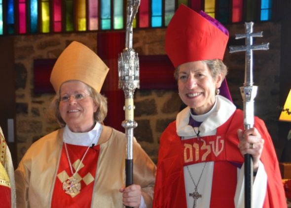 U.S. Episcopal Bishop Katharine Jefferts Schori presides over the consecration of Heather Cook (left) as bishop suffragan last September.