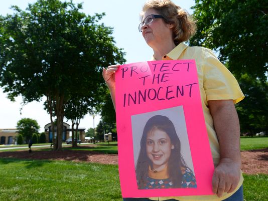 Abuse survivors and their supporters gathered outside of Bob Jones University on Thursday with signs.