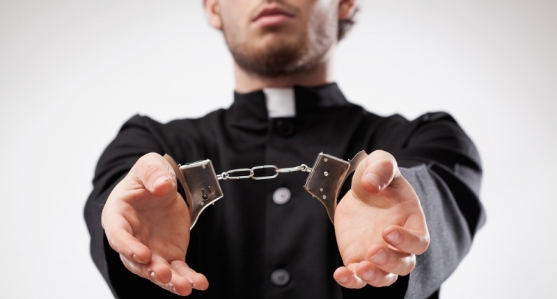 A religious leader in handcuffs (Shutterstock)