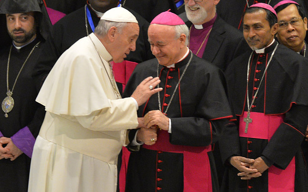 Pope Francis (L) greets archbishop Vincenzo Paglia earlier this year