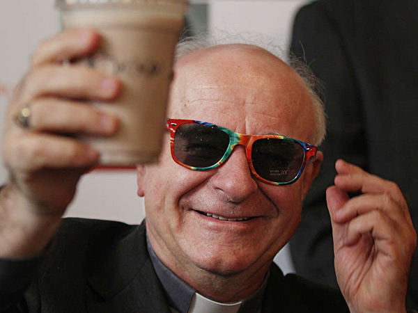 March 2015: Archbishop Vincenzo Paglia, in rainbow sunglasses, holds up the official papal milkshake at Potbelly Sandwich Shop. Michael Bryant/Staff Photographer