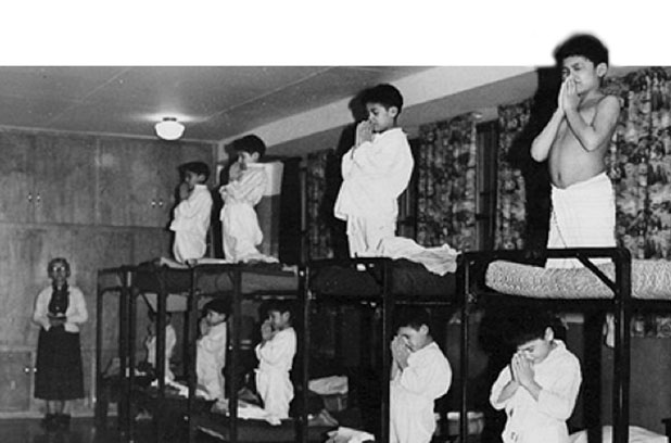 Residential SchoolsSwampy Cree boys kneel before to pray before bedtime under the watchful eye of an Anglican supervisor. (Shingwauk Residential Schools Centre)