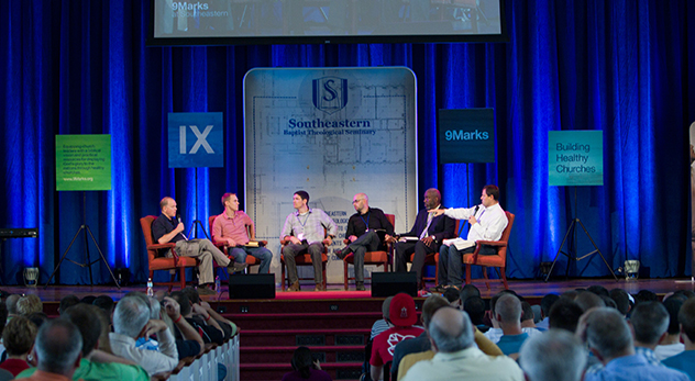 Hundreds of ministers and seminary students attend a IX Marks conference in 2012 at Southeastern Baptist Theological Seminary in Wake Forest, NC. From left: Daniel Akin, President of Southeastern Seminary; David Platt, president of International Mission Board; Matt Chandler, pastor of The Village Church; Jonathan Leeman, editorial director of IX Marks; Thabiti Anyabwile, assistant pastor for church planting at Capitol Hill Baptist Church; Mark Dever, founder of IX Marks. (Image courtesy of Southeastern Baptist Theological Seminary)