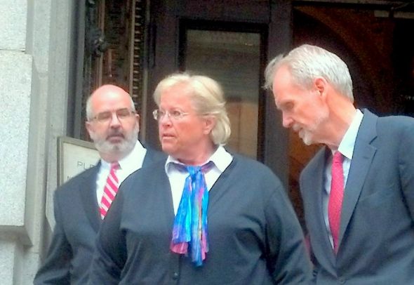 Heather Cook, flanked by her attorneys Jose Molina (left) and David Irwin, leaves the Mitchell Courthouse in Baltimore today.