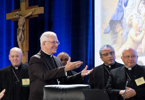 Archbishop Joseph Kurtz (center) of Louisville, Ky., the president of the U.S. Conference of Catholic Bishops, greets new members of the U.S. Conference of Catholic Bishops' during the Spring General Assembly in St. Louis on Wednesday, June 10, 2015. (AP Photo/Sid Hastings)