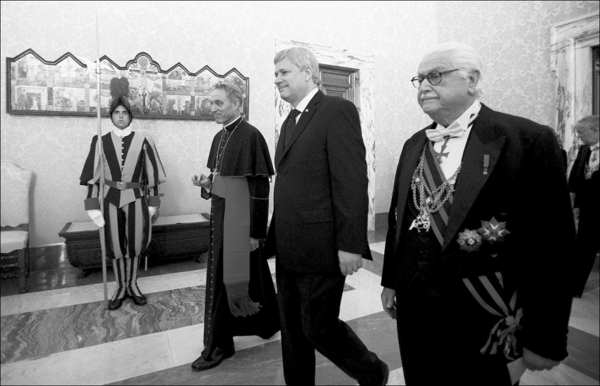 Prime Minister Stephen Harper is escorted to a meeting with Pope Francis at the Vatican on Thursday. At the meeting, Harper indirectly brought up the issue of the Catholic Church apologizing for the residential schools scandal.