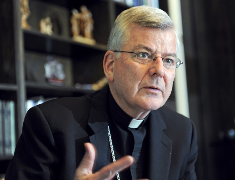 Archbishop John Nienstedt talks with a reporter at his office in St. Paul, Minn. in 2014. The archbishop of St. Paul, Minnesota, and a deputy bishop have resigned after prosecutors there charged the archdiocese with having failed to protect children from unspeakable harm from a pedophile priest. (AP Photo/Craig Lassig, File)