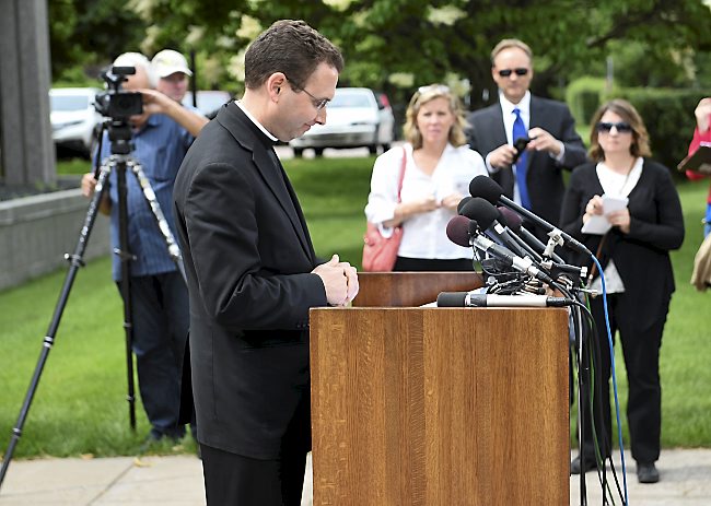 Auxiliary Bishop Andrew Cozzens announces the resignations of Archbishop John Nienstedt and Auxiliary Bishop Lee Anthony Piche during a news conference at the Archdiocese of St. Paul and Minneapolis headquarters in St. Paul on June 15. (AP Photo/Craig Lassig)