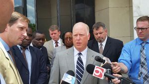U.S. Attorney Sanford Coats, center, and lead prosecutor Robert D. Gifford II, left, speak to the media Friday after a seven-man, five-woman jury found Matthew Lane Durham guilty of sexually abusing Kenyan children.