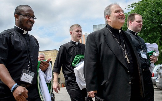 Archbishop Bernard Hebda, center, inherits a church community rocked by scandal and in bankruptcy.