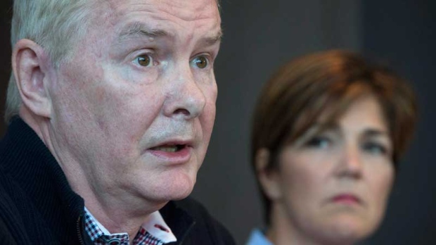 John Furlong addresses the media from his lawyer's office in Vancouver, Tuesday, March 31, 2015 as Renee Smith-Valade looks on. (THE CANADIAN PRESS/Jonathan Hayward)