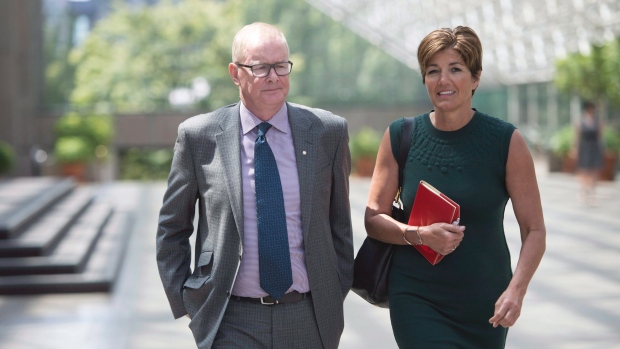 Former Vancouver Olympics CEO John Furlong and his partner, Renee Smith-Valade, leave B.C. Supreme Court during a break in civil defamation proceedings against Furlong. (Jonathan Hayward/Canadian Press)
