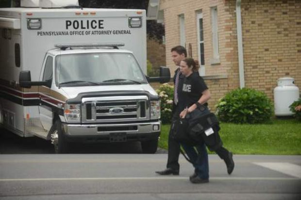 Dan Dye (rear), deputy attorney general, walks with an investigator with the state Attorney General's Office as they collect evidence at the St. Bernardine Monastery in Hollidaysburg on Thursday, June 25, 2015. (Evan Sanders | Trib Total Media, Staff)