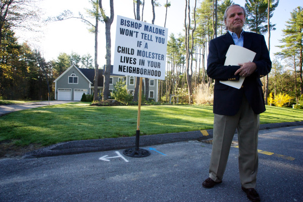 Paul Kendrick of the Ignatius Group protests outside former Bishop Richard Malone's house in Falmouth Thursday April 26, 2012. Buy Photo