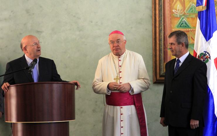 Former papal nuncio Jozef Wesolowski (center), accused of sexually abusing boys during his tenure as the Vatican's ambassador to the Dominican Republic, was hospitalized ahead of his trial on Saturday. Pictured: Wesolowski, Dominican Foreign Minister Carlos Morales Troncoso (L) and Colombian ambassador to the Dominican Republic, General (ret) Mario Montoya during a ceremony in Santo Somingo, on August 12, 2011. Getty Images/AFP/ERIKA SANTELICES