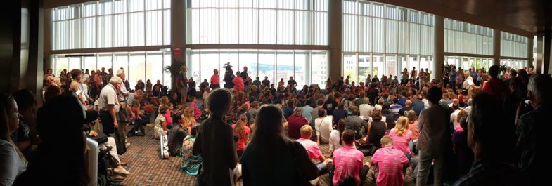 Pink Meno hymn sing on Saturday, July 4, 2015 outside the delegate assembly at the Mennonite Convention in Kansas City. It was the largest ever hymn sing with well over 300 people joining in.