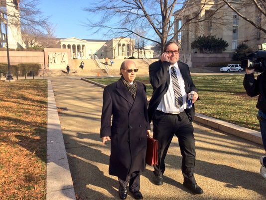 Rabbi Barry Freundel talks on the phone while walking away from court on Jan. 16, 2015