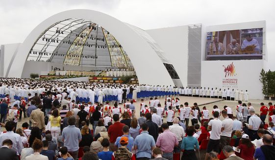 Faithful gather in Bresso, near Milan, Italy, to follow a Mass celebrated by Pope Benedict XVI in this Sunday, June 3, 2012, file photo. (AP Photo/Antonio Calanni/File) more >