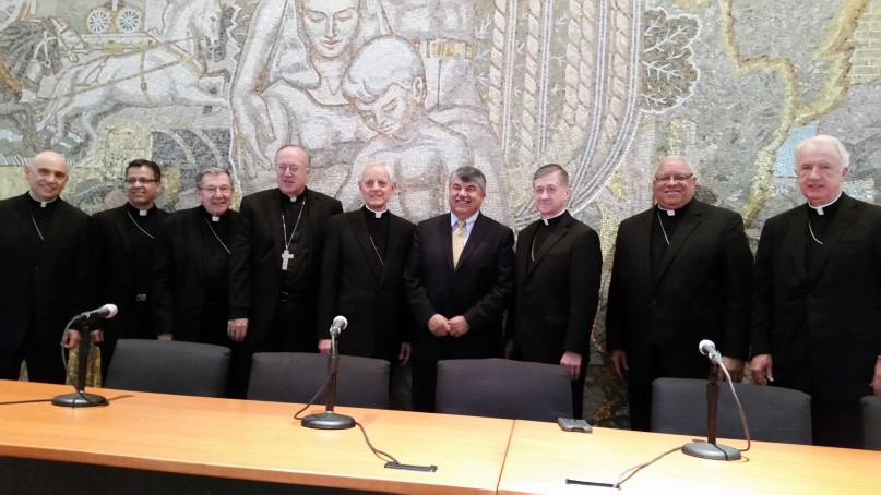 Chicago Archbishop Blase Cupich, third from right, stands next to AFL-CIO chief Richard Trumka at a June 15 event on economics and the Catholic Church in Washington, D.C. Youngstown, Ohio, Bishop George Murry is next to Cupich. Religion News Service photo by Mark Silk