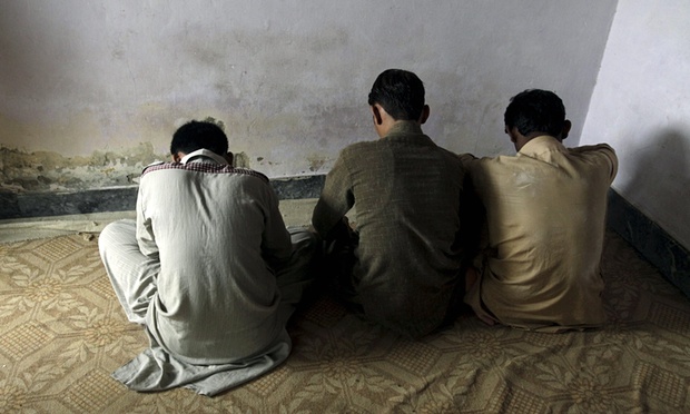 Children whose families say have been abused turn their backs to the camera while being interviewed in Hussain Khan Wala, Punjab province, Pakistan. Photograph: Mohsin Raza/Reuters