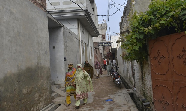 Villagers walk through the streets of Hussain Khan Wala. A lawyer believes every third house in the village has been affected by the abuse. Photograph: Arif Ali/AFP/Getty Images