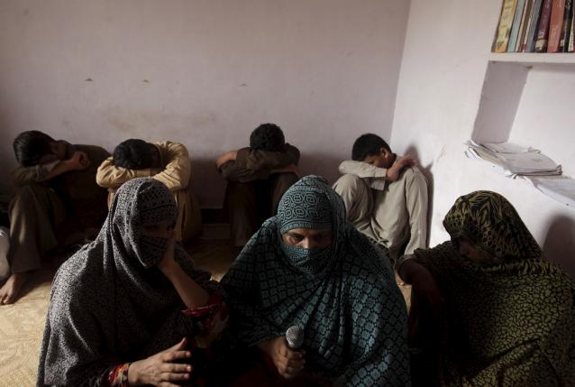 Children whose families say have been abused, hide their faces while their mothers are interviewed by a Reuters correspondent in their village of Husain Khan Wala, Punjab province, Pakistan August 9, 2015.