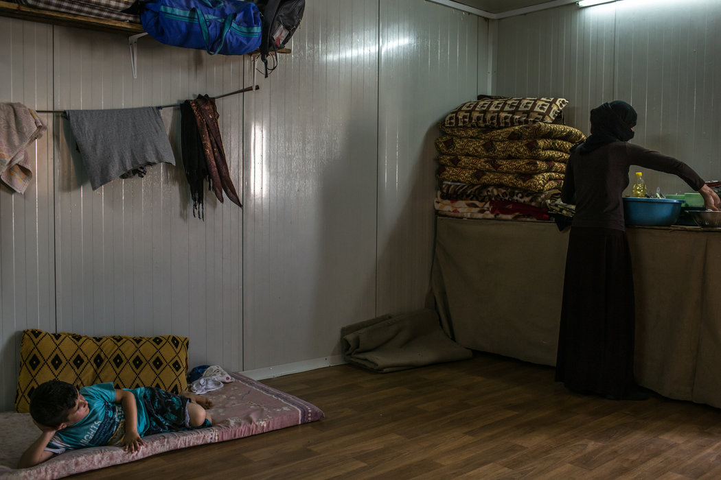 A woman from the village of Tojo washing dishes in a refugee camp in Kurdistan. She was held by the Islamic State from last August until June and says she was sexually abused.
