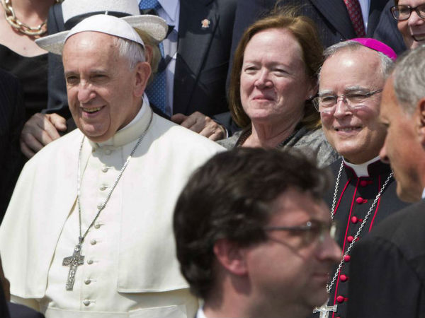 FILE - In this Wednesday, June 24, 2015 file photo, Philadelphia's Archbishop Charles Chaput, right, stands next to Pope Francis as they pose for a photo with a delegation from Philadelphia at the end of the pontiff's weekly general audience in St. Peter's Square at the Vatican. Pope Francis will be traveling to Philadelphia in September to attend the World Meeting of Families. Chaput, the meeting's host, is moving to limit lesbian, gay, bisexual and transgender Roman Catholics as they try to lobby for a broader role in the event. (AP Photo/Riccardo De Luca)