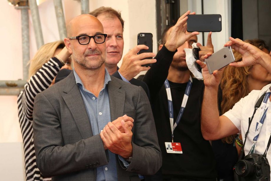 Stanley Tucci and Thomas McCarthy watch as Mark Ruffalo poses for photographers at the photo call for the film Spotlight during the 72nd edition of the Venice Film Festival in Venice, Italy, Thursday, Sept. 3, 2015. The 72nd edition of the festival runs until Sept. 12. (Photo by Joel Ryan/Invision/AP)