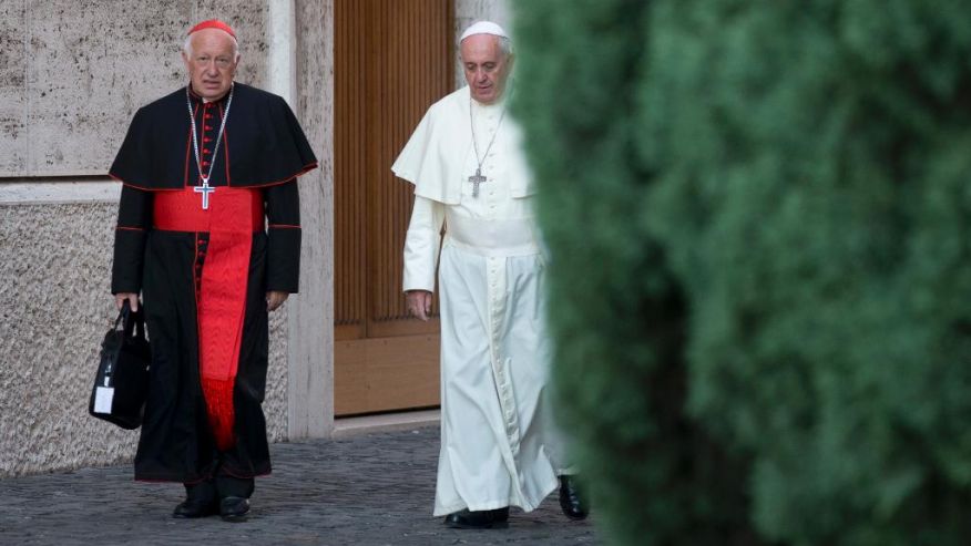 FILE - In this Oct. 9, 2014 file photo, Pope Francis, right, walks with Chile's Cardinal Ricardo Ezzati to a session of the synod, a two-week meeting of cardinals and bishops from around the world, at the Vatican. Private e-mails show that Ezzati exchanged messages with his predecessor, Cardinal Francisco Javier Errazuriz, to try to block a victim of sex-abuse by a pedophile priest from joining the papal commission. The Archbishop of Santiago de Chile has confirmed the authenticity of the e-mails. (AP Photo/Alessandra Tarantino, File) (The Associated Press)