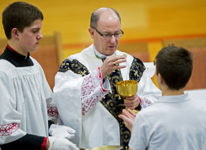 Bishop James Conley offers holy communion to a student during the "Grandparents Day" all-school mass on Jan. 30, 2014 at Bishop Neumann High School in Wahoo.