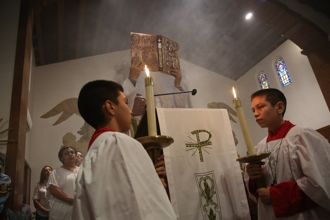 Altar boys with Father Reynaga during Mass at Sacred Heart Church. More than half of the Catholics younger than 25 in the United States are Hispanic.