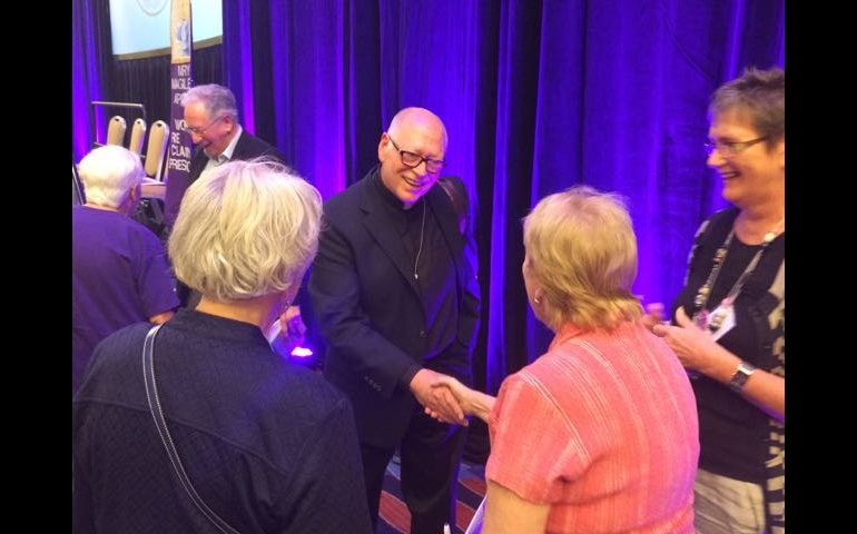 Fr. Jack McClure greets women after WOW panel. (NCR photo/Tom Fox)