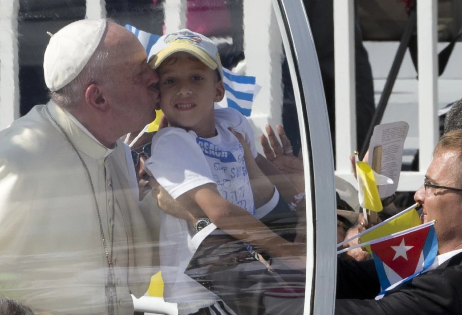 Pope Francis kisses a child as he arrives at the Plaza of the Revolution to celebrate a Mass, in Holguin, Cuba, Monday, Sept. 21, 2015. Francis arrives in Washington on Monday, and will find a Catholic lobby that is very powerful politically. (AP Photo/Alessandra Tarantino)