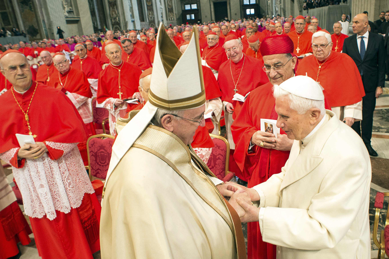 Pope Francis, left, greets Emeritus Pope Benedict XVI during a Mass to create 20 new cardinals during a ceremony in St. Peter’s Basilica at the Vatican on Feb. 14, 2015. RNS photo courtesy REUTERS/Osservatore Romano. *Editors: This photo can only be used with RNS-NEW-CARDINALS, transmitted Feb. 14, 2015, and with RNS-POPE-CURIA, originally published on Sept. 23, 2015.