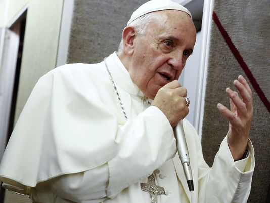 Pope Francis address the crew and press core aboard the papal plane while en route to Italy on September 28, 2015.