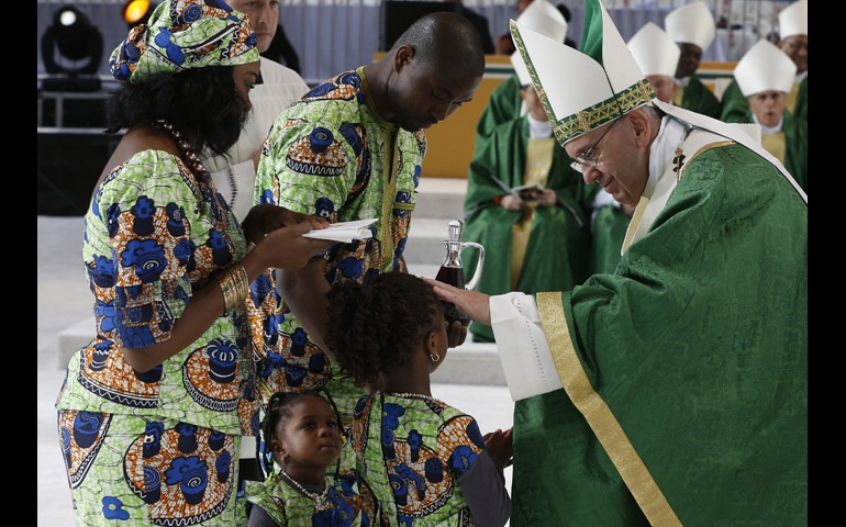 Pope Francis blesses a girl as her family presents offertory gifts during the closing Mass of the World Meeting of Families along Benjamin Franklin Parkway in Philadelphia Sept. 27. (CNS/Paul Haring)