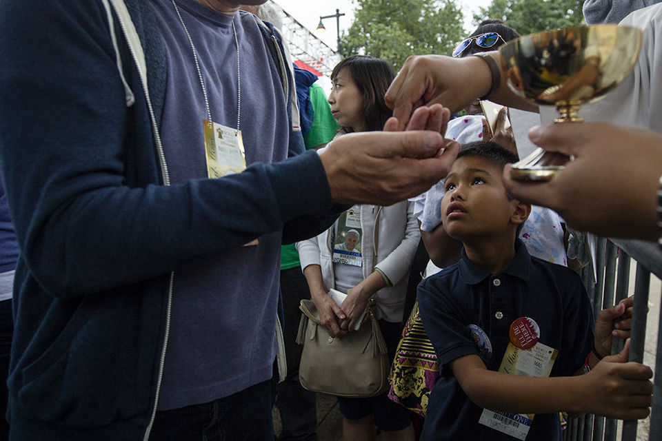 Communion is received during Sunday Mass lead by Pope Francis on Benjamin Franklin Parkway.Sept. 27, 2015. Amanda Berg, PennLive