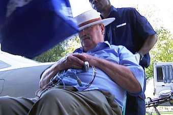 PHOTO: William John Keith Ellis is taken from court by ambulance officers in 2009. (ABC News)