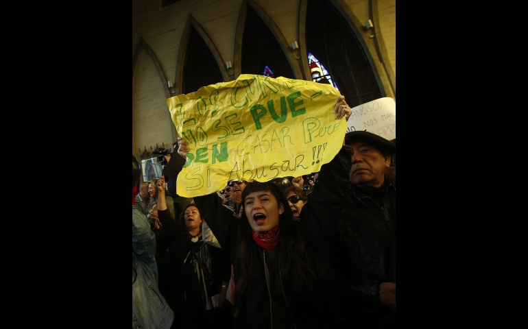 Demonstrators in Chile protest against Bishop Juan Barros inside the Cathedral of St. Matthew in Osorno, Chile, March 21. (CNS photo/Felipe Trueba, EPA