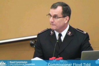 HOTO: Salvation Army commissioner Floyd Tidd apologises to survivors of child sex abuse at the organisation's children's homes last century. (ABC News)