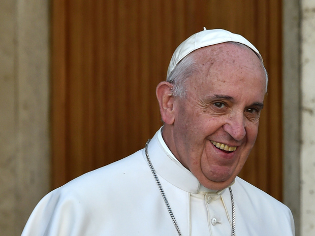 Pope Francis smiles as he leaves for a break during the Synod on the family at the Vatican on October 15, 2015.