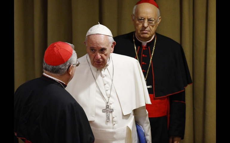 Pope Francis speaks with a cardinal as he arrives for a session of the Synod of Bishops on the family at the Vatican Oct. 15. At right is Cardinal Lorenzo Baldisseri, general secretary of the Synod of Bishops. (CNS/Paul Haring)