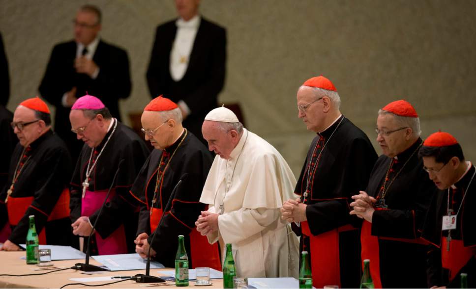 Pope Francis, center, delivers his blessing at the end of a meeting marking the 50th anniversary of the creation of the Synod of Bishops, in the Paul VI hall at the Vatican, Saturday, Oct. 17, 2015. (AP Photo/Alessandra Tarantino)