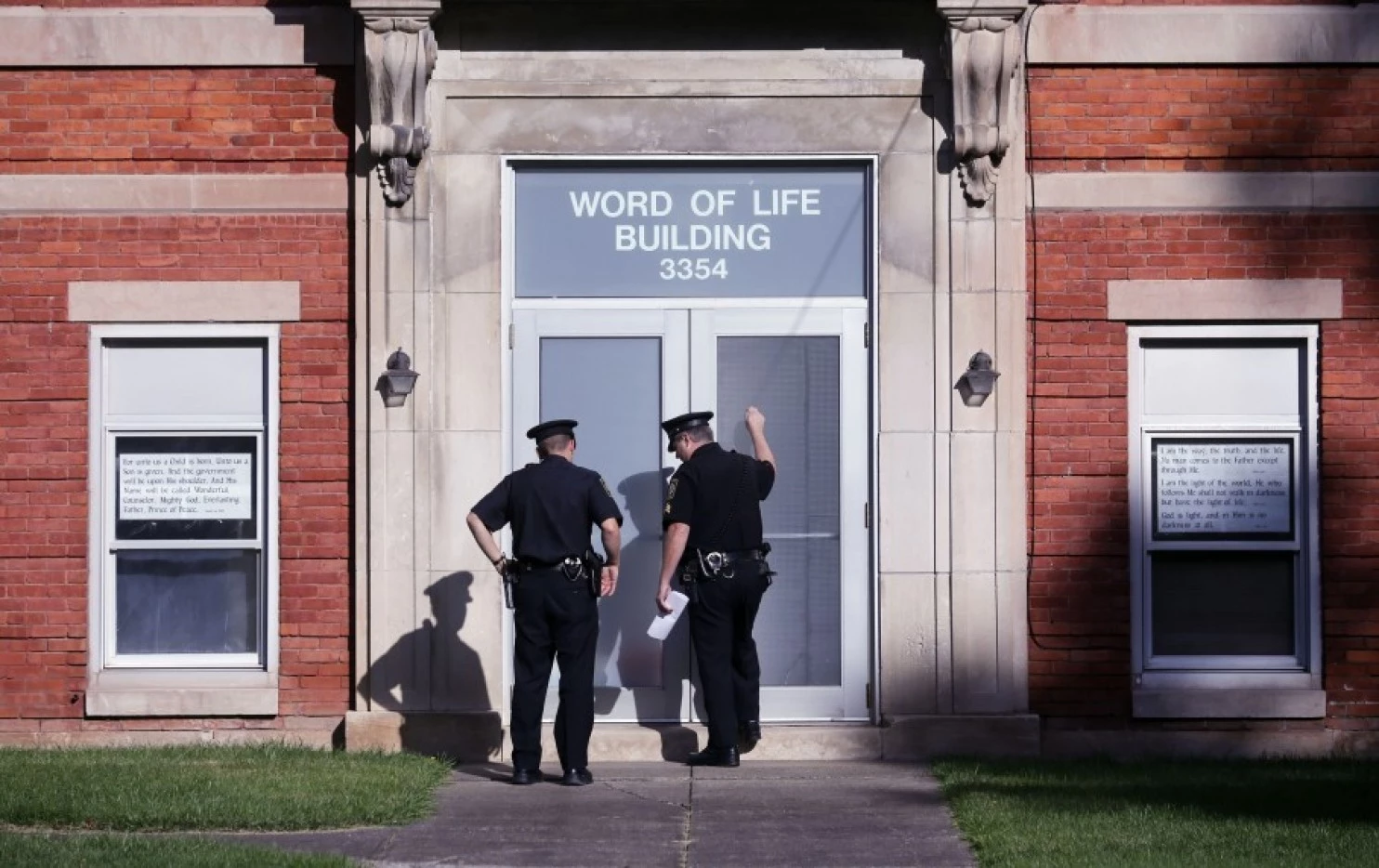 Police knock on the door of the Word of Life church while serving paperwork on a church member on Oct. 15 in New Hartford, N.Y. (Mike Groll/AP)