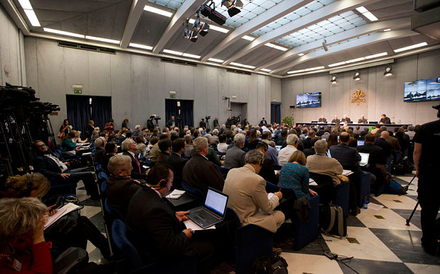 Journalists crowd the Vatican press center as Vatican spokesman Rev. Federico Lombardi talks to the media during a press conference Photo: AP/Andrew Medichini