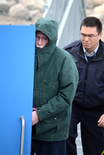 An RCMP officer leads Eric Dejaeger into the Nunavut Court of Justice in Iqaluit earlier this year during his trial (FILE PHOTO)